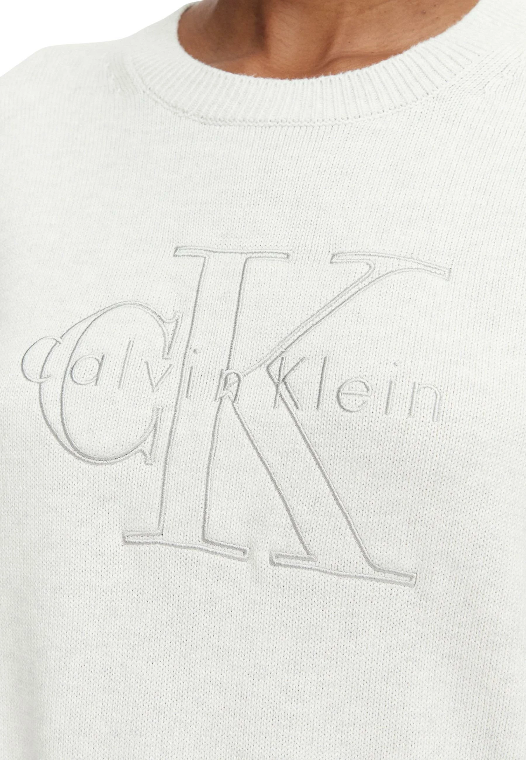 Xhemper për femra Calvin Klein Jeans LV047G322G, gri e çelët [Madhësia: S]